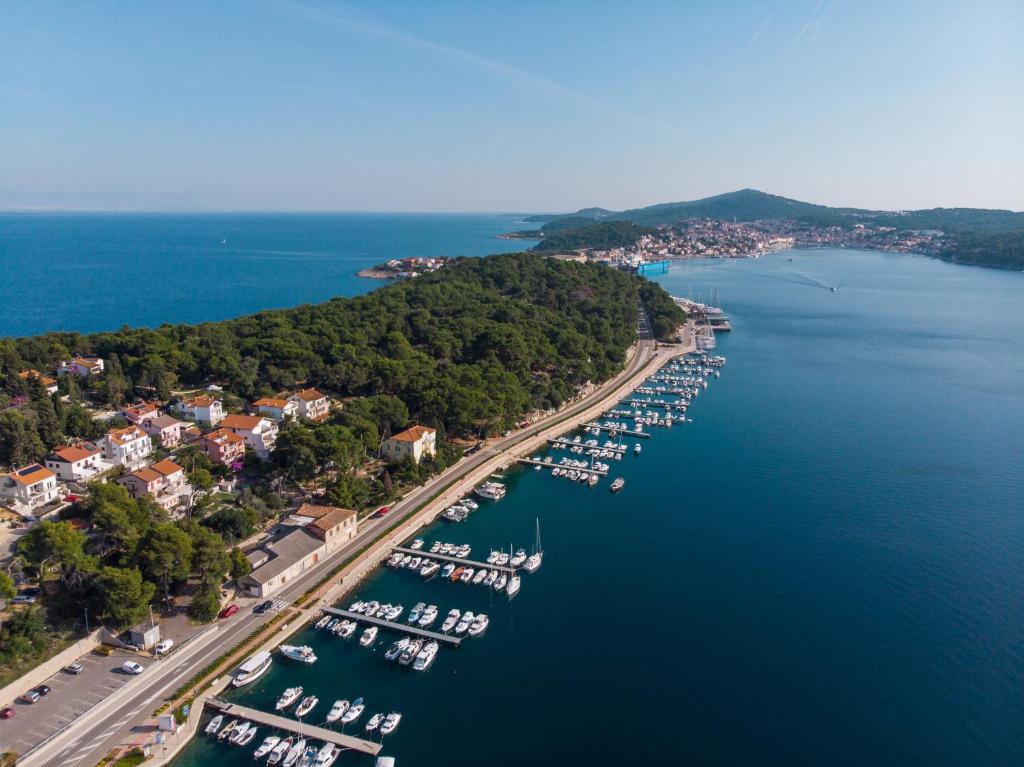 an aerial view of a harbor with boats in the water at Exclusive Apartments Milahomes by the sea, boot mooring and private parking in Mali Lošinj