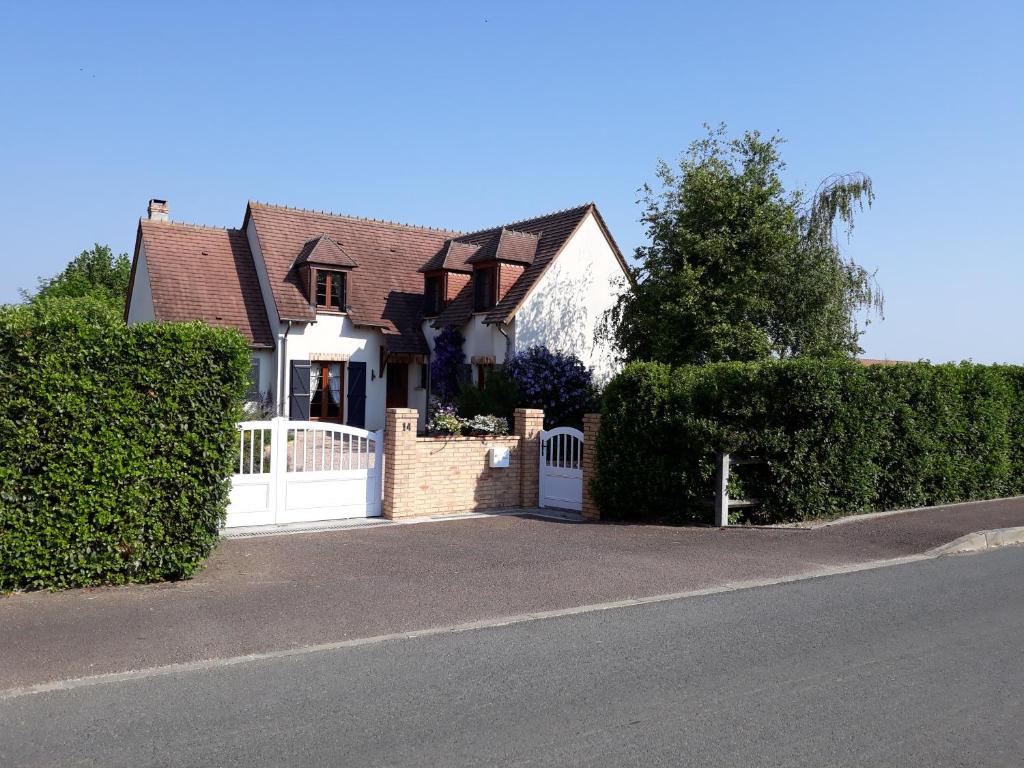 a house with a white gate and a fence at Thérouanne en Berry in Plaimpied-Givaudins
