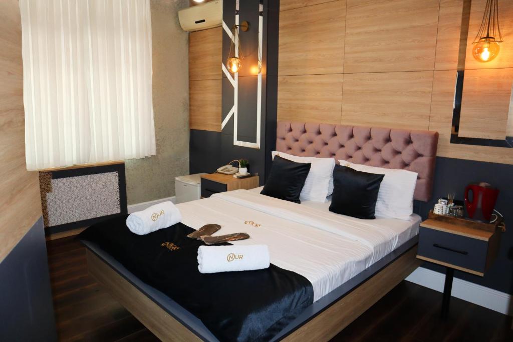 a bedroom with a large bed with two towels on it at Grand Onur Hotel in Istanbul