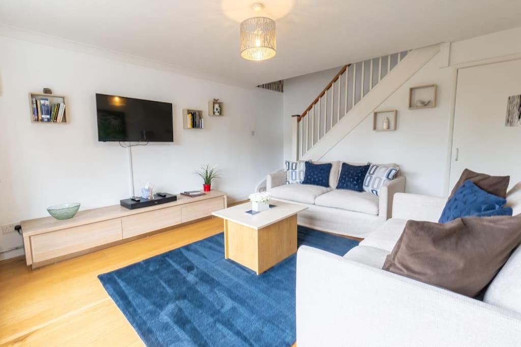 a living room with a couch and a tv at 1 Regent Square, Rye - for a perfect break in Rye