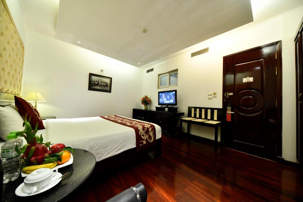 Postel nebo postele na pokoji v ubytování Hanoi Traveller House