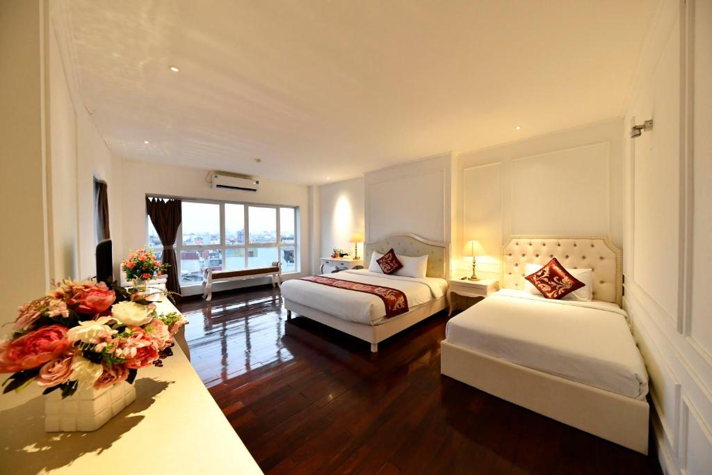 Postel nebo postele na pokoji v ubytování Hanoi Traveller House