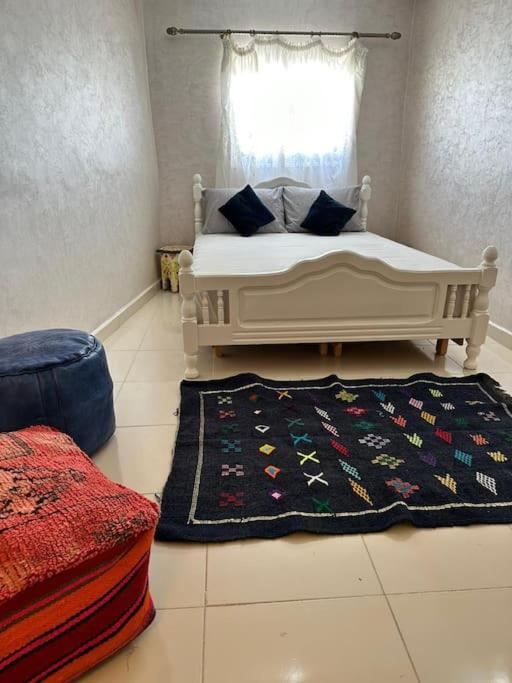 a bedroom with a bed with a rug and a window at House with sea view in Kasbah in Tangier