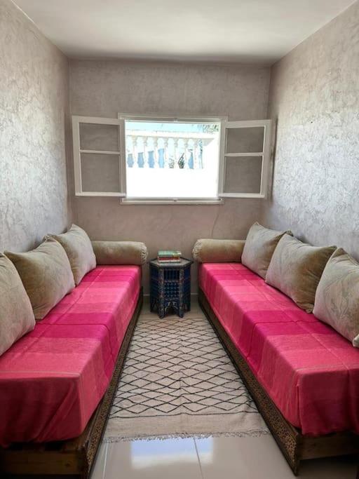 a living room with a couch with pink cushions at House with sea view in Kasbah in Tangier