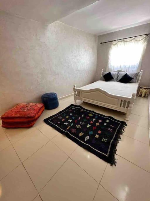 a bedroom with a bed and a rug on the floor at House with sea view in Kasbah in Tangier
