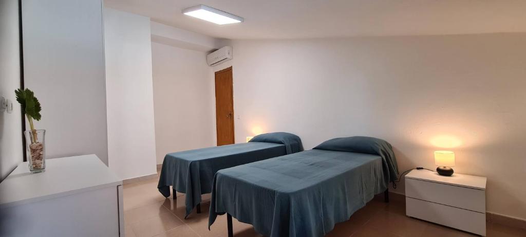 Postel nebo postele na pokoji v ubytování A 2 passi dalla spiaggia