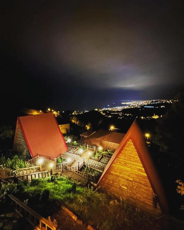 a building with a red roof at night at Antikhouse Bungalow&Cafe in Akcaabat