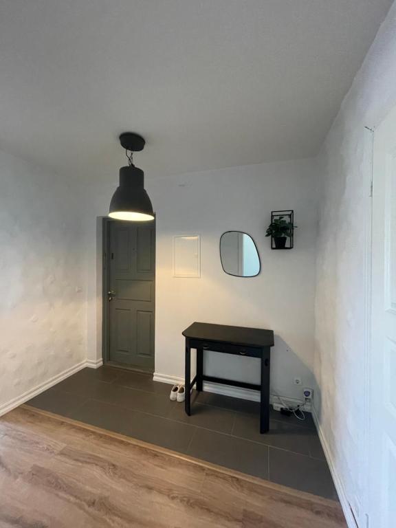 a room with a table and a door and a light at Tallinn Street Apartment in Kuressaare