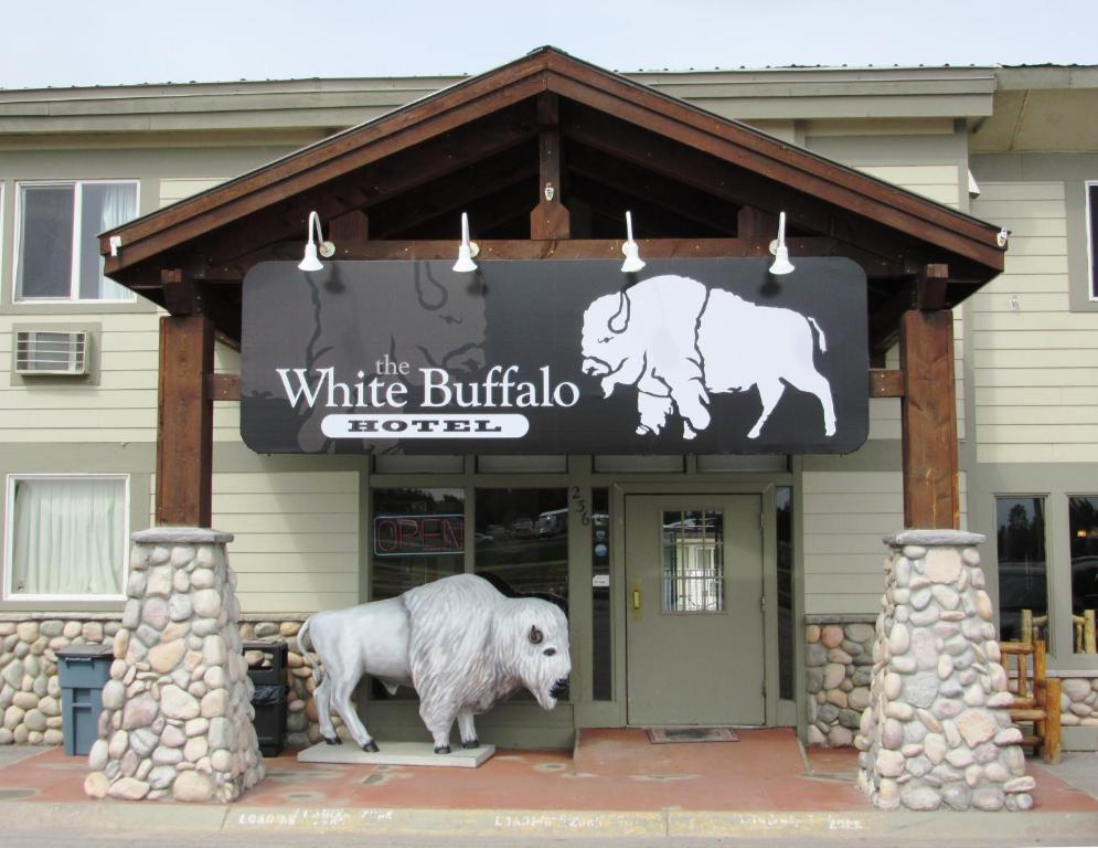 a sign for a white buffalo hotel with two bulls at White Buffalo Hotel in West Yellowstone