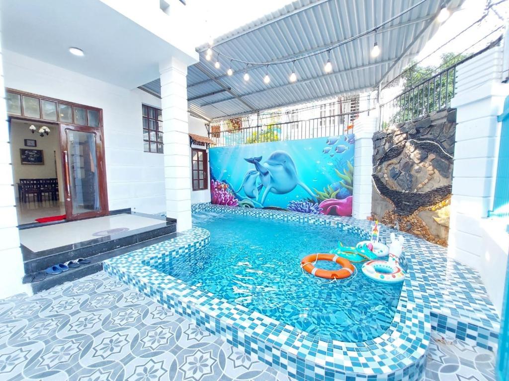 a swimming pool in a house with a mermaid mural at Villa 47 - Gần Biển Bãi Sau - Phòng Khách Có Máy Lạnh in Vung Tau