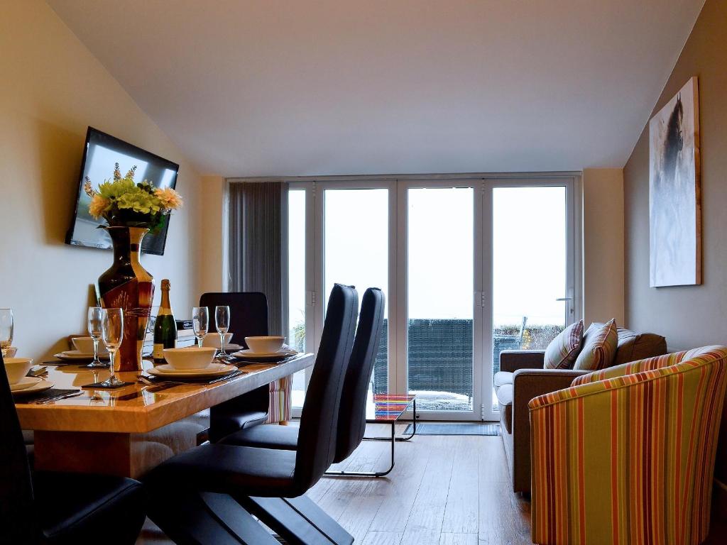 a dining room with a table and chairs with a view at The Retreat in Woolaston