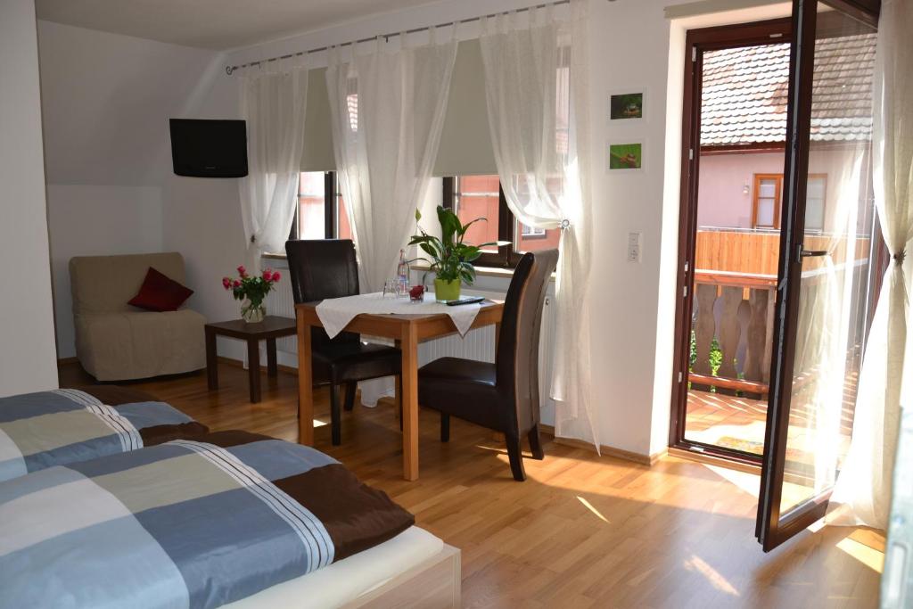 a bedroom with a table and a room with a bed at Baumeisterhaus in Dinkelsbühl