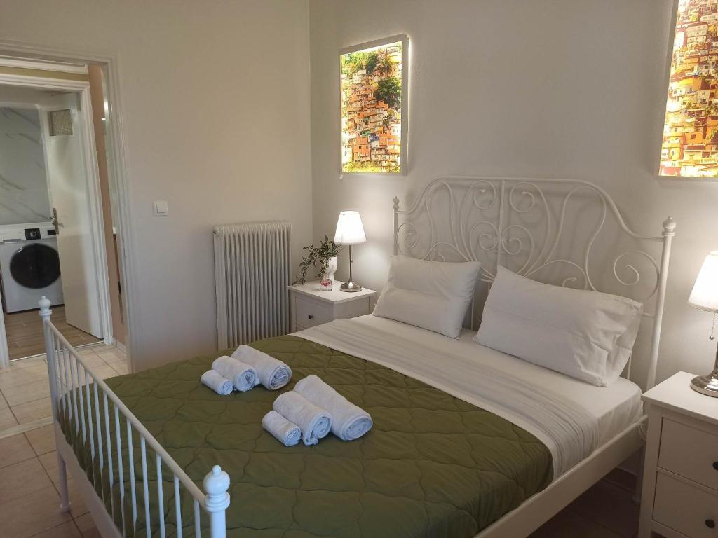 a bedroom with a bed with two towels on it at limonchello 2 in Kalamata