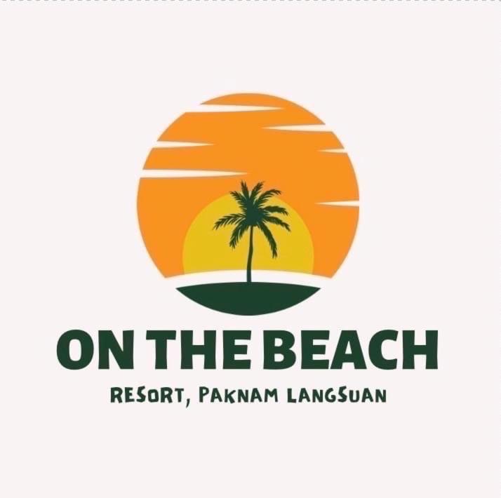 a beach logo with a palm tree on the beach at Onthebeach resort in Ban Hin Sam Kon