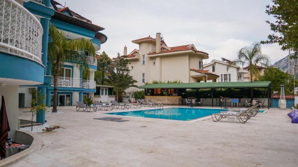 a resort with a swimming pool in a courtyard at EGE APART HOTEL in Marmaris