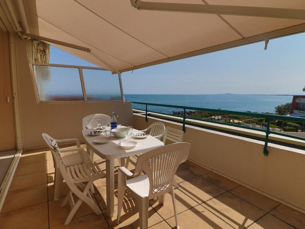 une table et des chaises sur un balcon avec vue sur l'océan dans l'établissement Spacieux 34m² avec clim, WIFI, loggia et terrasse pour 6 pers à Sète - FR-1-472A-182, à Sète