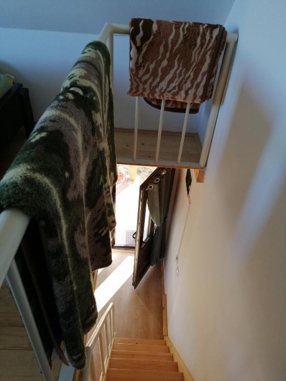 a stairway with a blanket and a chair in a room at Tarin zov in Kaludjerske Bare