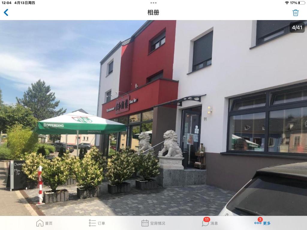 a building with a statue in front of a building at Sanhe in Rollingen