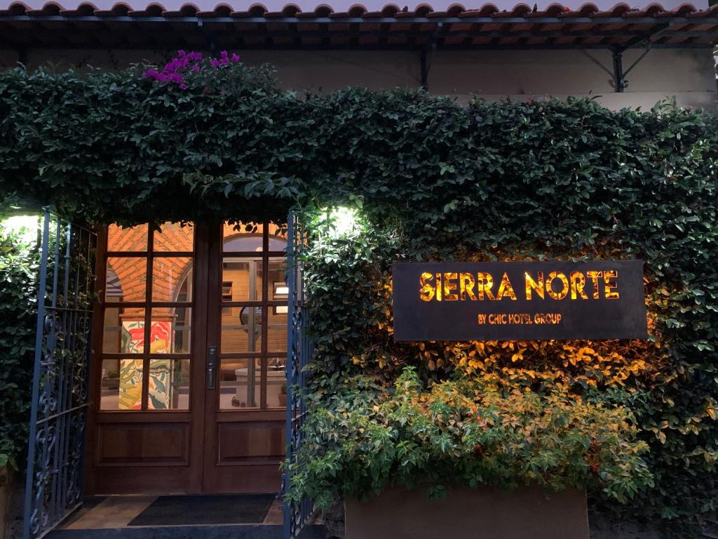 a sign for the entrance to a starina note restaurant at Sierra Norte By Chic Hotel Group in Tepoztlán