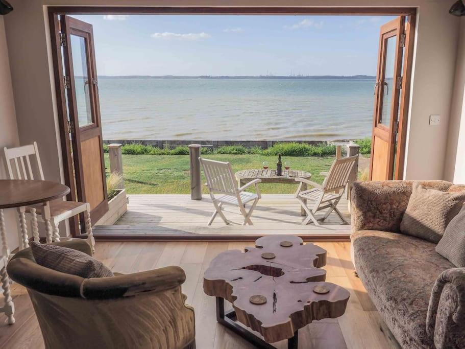 a living room with a view of the ocean at Beachside chalet 3 Cormorant with access to beach in Cowes