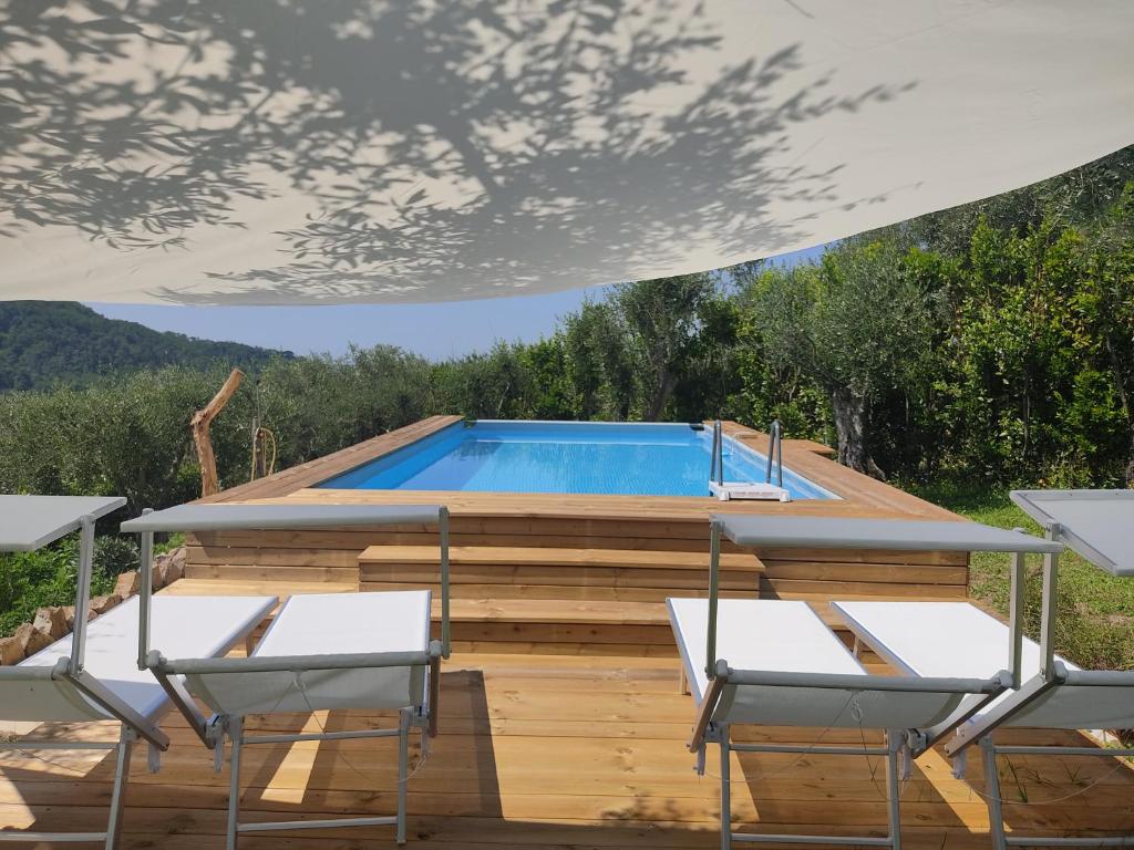 a pool in a house with two chairs at la tana del geco in Massarosa