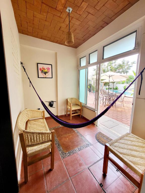 a hammock in a room with a patio at Casa Puerto Bonito & Private Coworking in Puerto Escondido