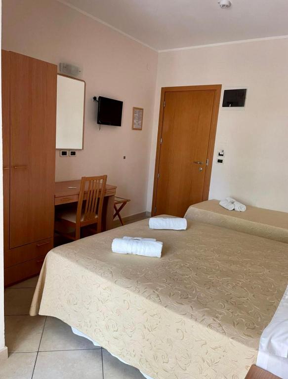 Postel nebo postele na pokoji v ubytování Hotel Favorita