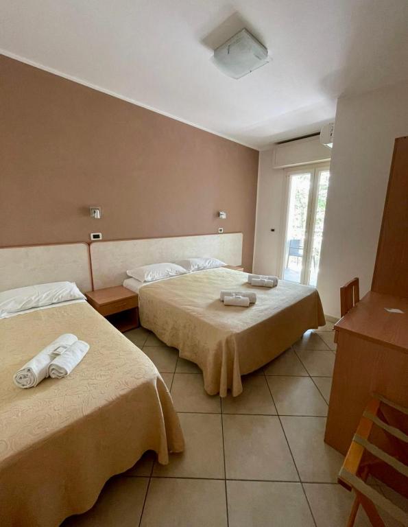 Postel nebo postele na pokoji v ubytování Hotel Favorita