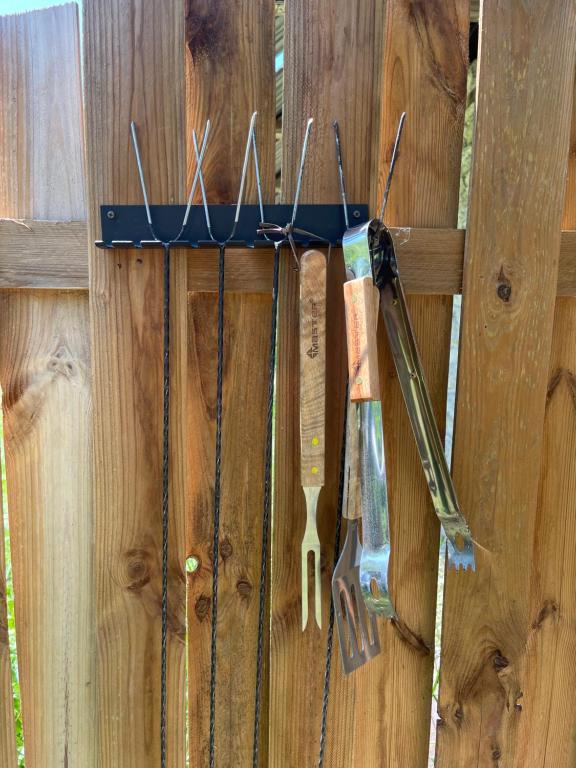 a bunch of tools hanging on a wooden fence at Pod Jabłoniami - Roztocze Susiec Paary in Pary
