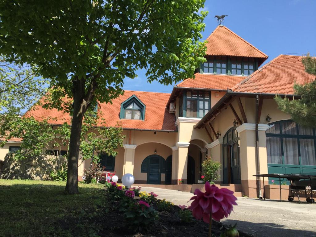 a large house with an orange roof at Garden Panzió in Balatonkeresztúr