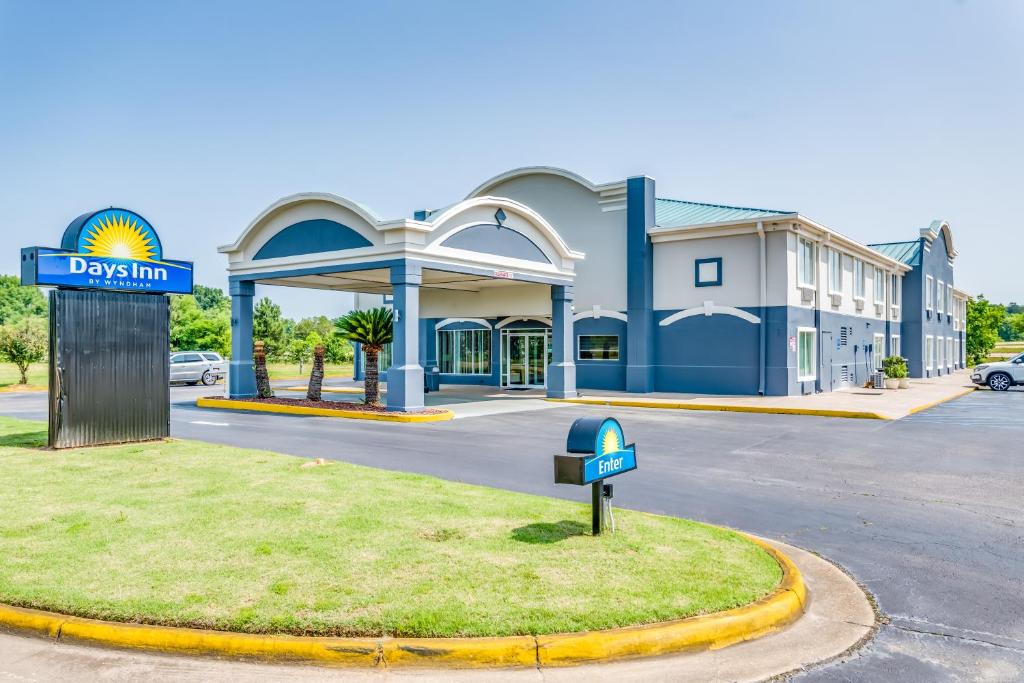 a gas station with a sign in front of it at Days Inn by Wyndham Coliseum Montgomery AL in Montgomery
