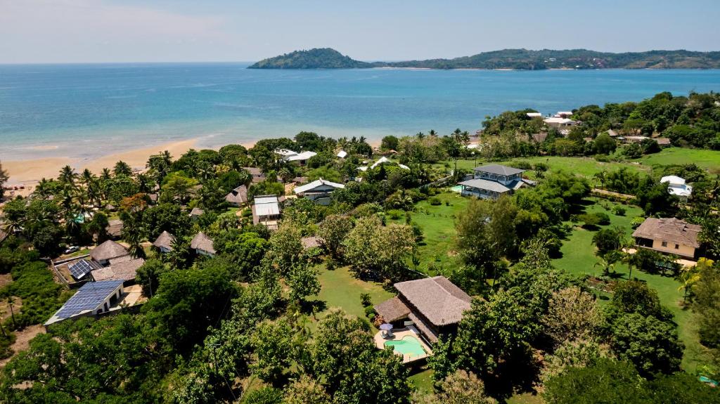 an aerial view of a house next to the ocean at Villa MILENA in Nosy Be
