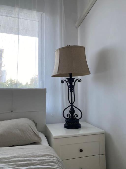 a lamp sitting on a night stand next to a bed at Serenity Apart in Antalya