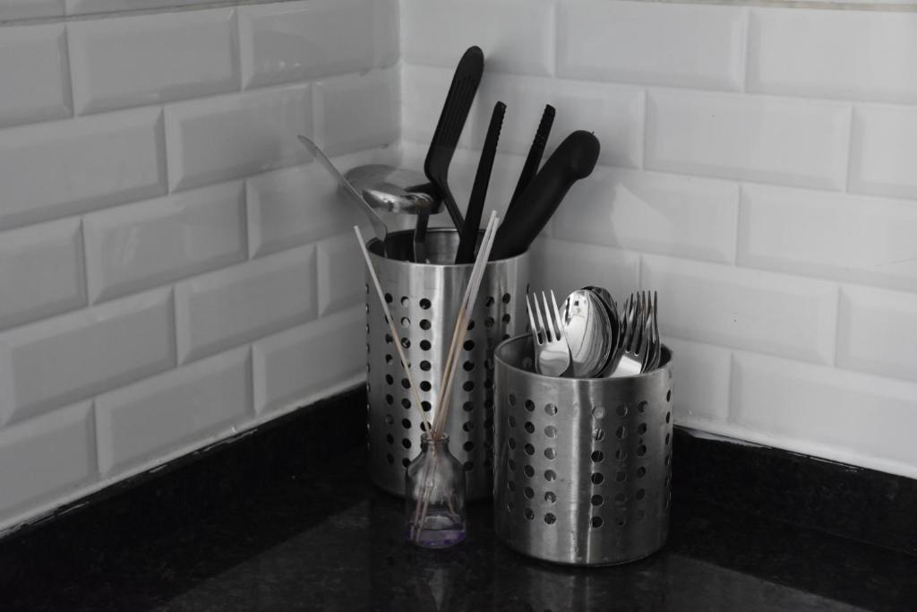 two metal containers with utensils on a counter at Serenity Apart in Antalya