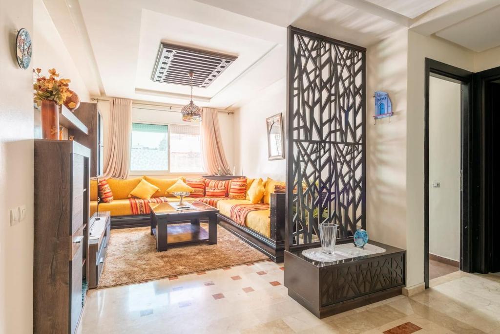 a living room with a couch and a table at Appartement Rabat Agdal City Centre in Rabat