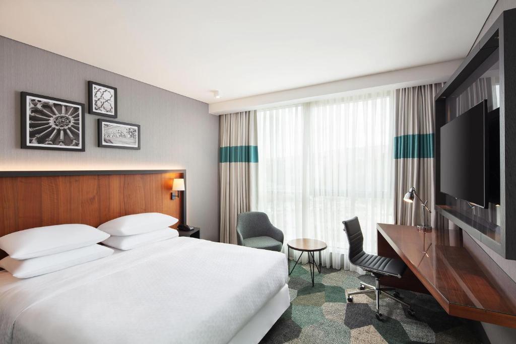 a hotel room with a bed and a desk and a television at Four Points by Sheraton Istanbul Kagithane in Istanbul
