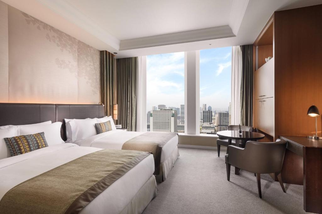 Postel nebo postele na pokoji v ubytování The St. Regis Osaka