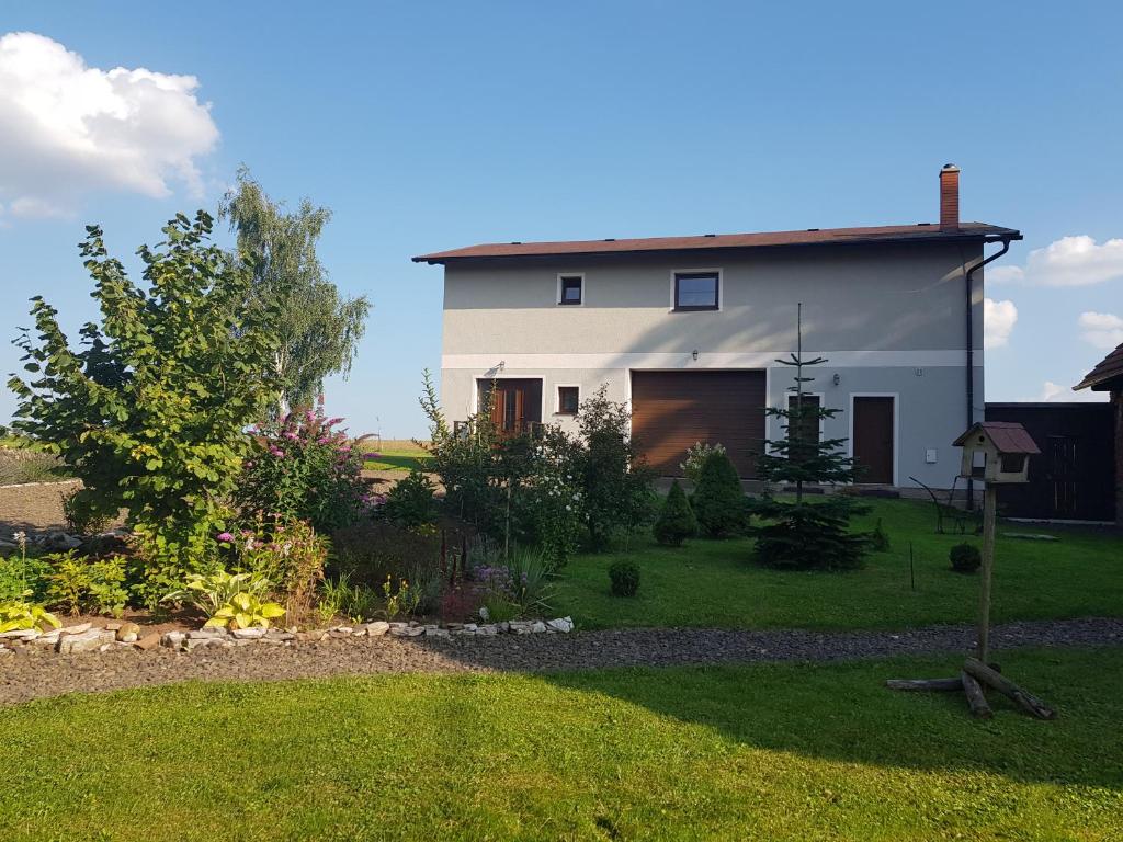 a white house with a garden in front of it at Domeček s výhledem in Martínkovice