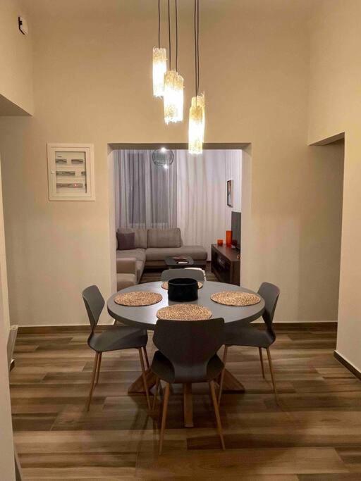 a dining room with a table and chairs in a room at Alani house in Tinos