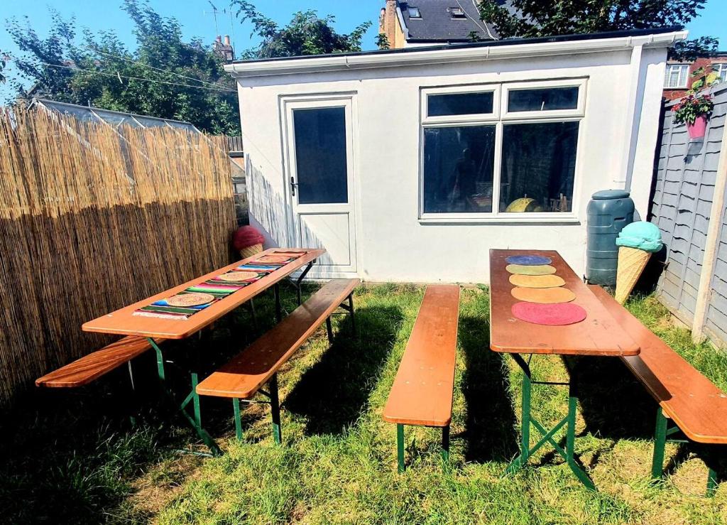 a picnic table and two benches in the yard at Casa Colour Margate in Margate