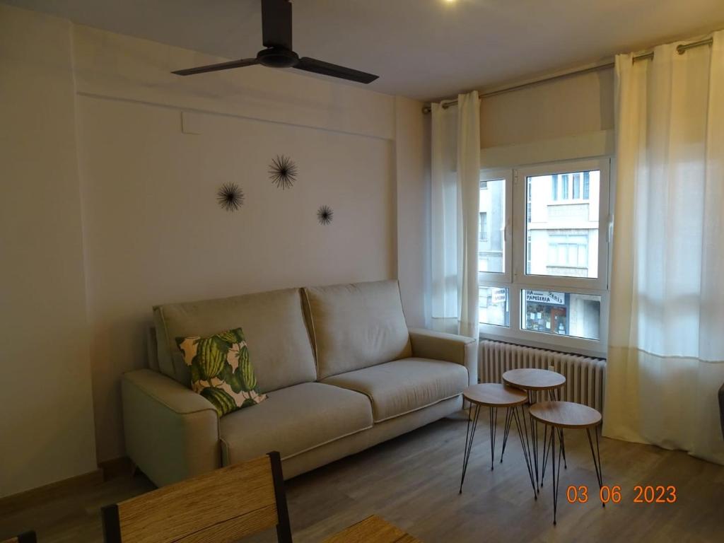 a living room with a couch and two tables at Apartamentos Cuéntame Burgos - VUT in Burgos