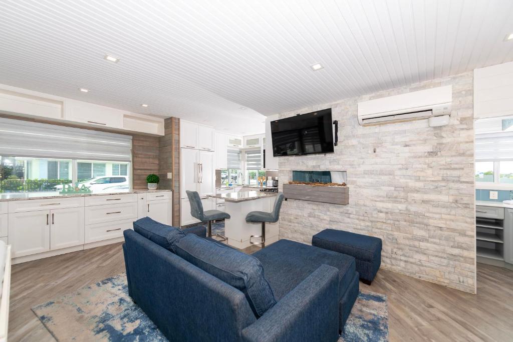 a living room with a blue couch and a brick wall at Tropic Isle Boutique Hotel in Hollywood