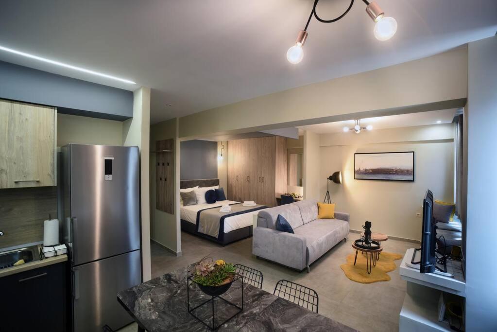 a kitchen and living room with a couch and a refrigerator at Porto Boutique #B in Thessaloniki