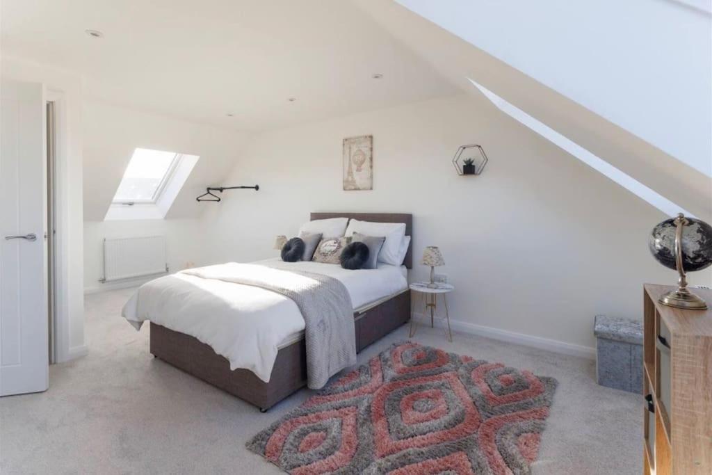 a white bedroom with a bed and a rug at Luxury 3-Bedroom, 2-Bathroom Home sleeps 7 people in Liverpool