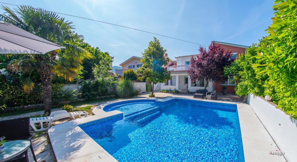 a swimming pool in the backyard of a house at Villa Fiori in Blagaj