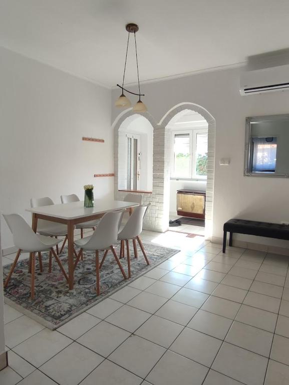 a dining room with a table and chairs at Baross Apartman in Tapolca
