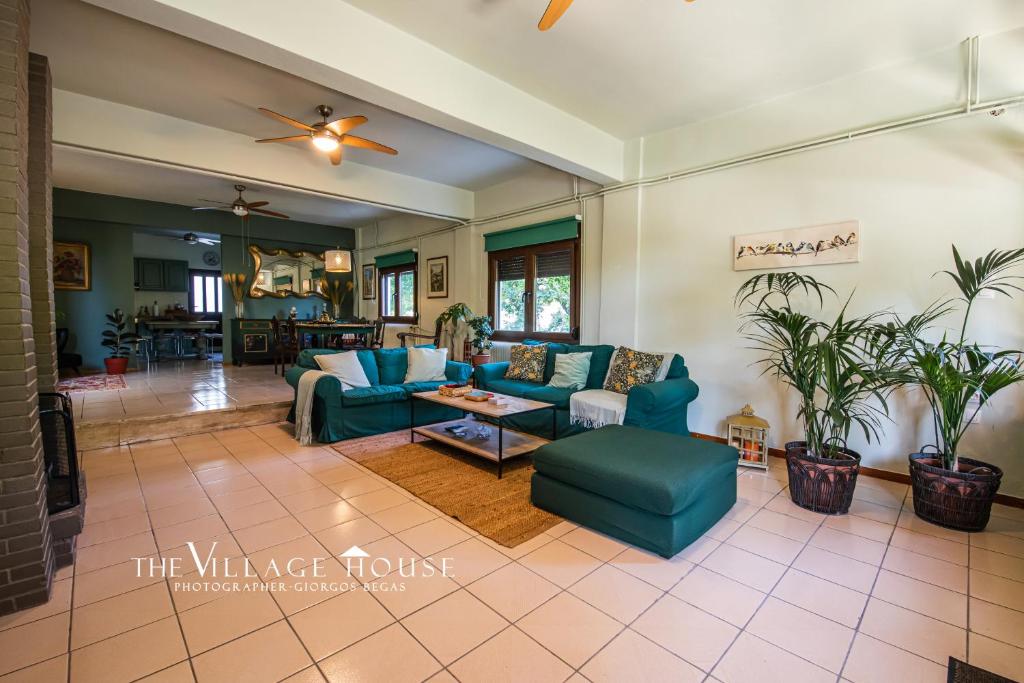 a living room with blue couches and a table at The Village House in Volos