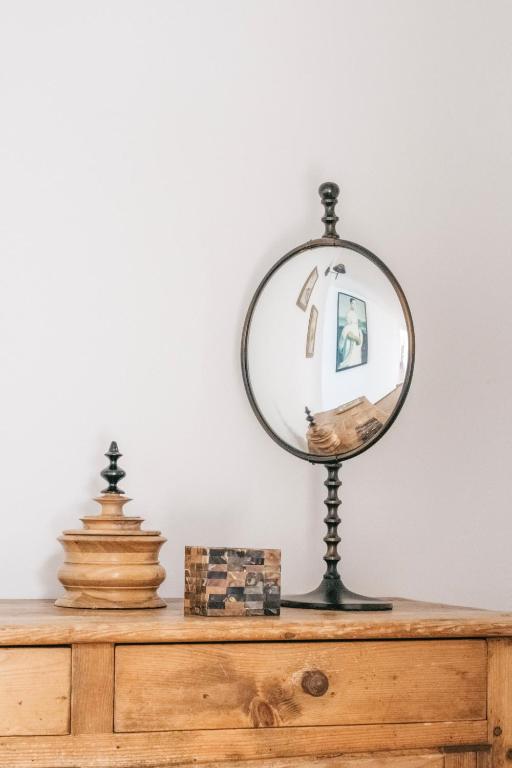 a mirror on top of a wooden dresser at Surplage Hotel Cavalière in Le Lavandou