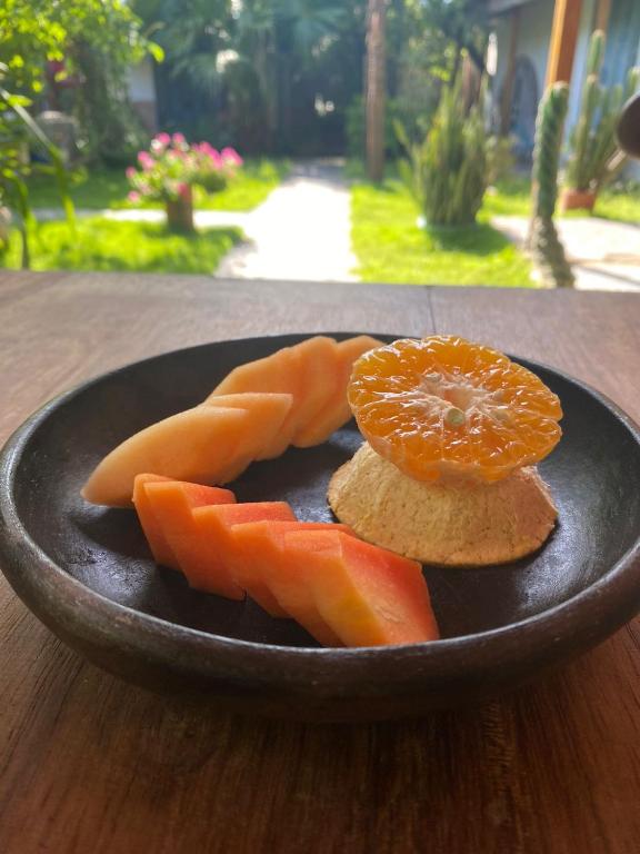 a plate of food with carrots and oranges on a table at Ekaa Hotel in Palomino