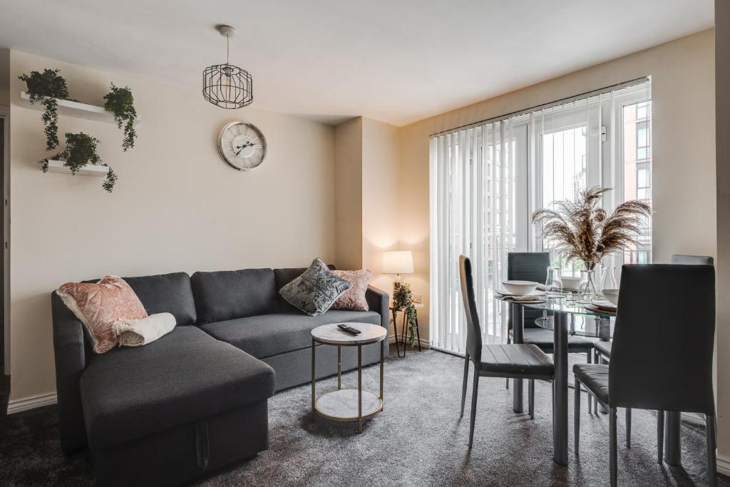 a living room with a couch and a table at Stylish 2 Bed Manchester Flat in Manchester